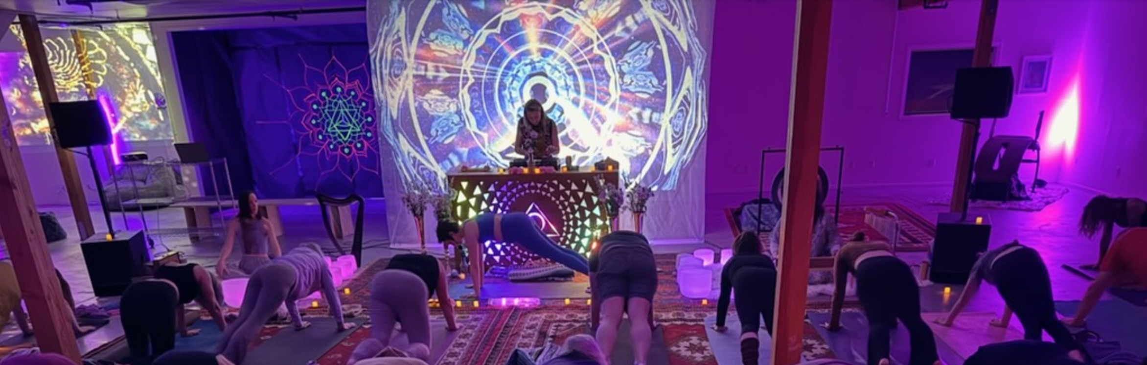 Deep House Yoga gathering with yoga, music, and colorful projected art
