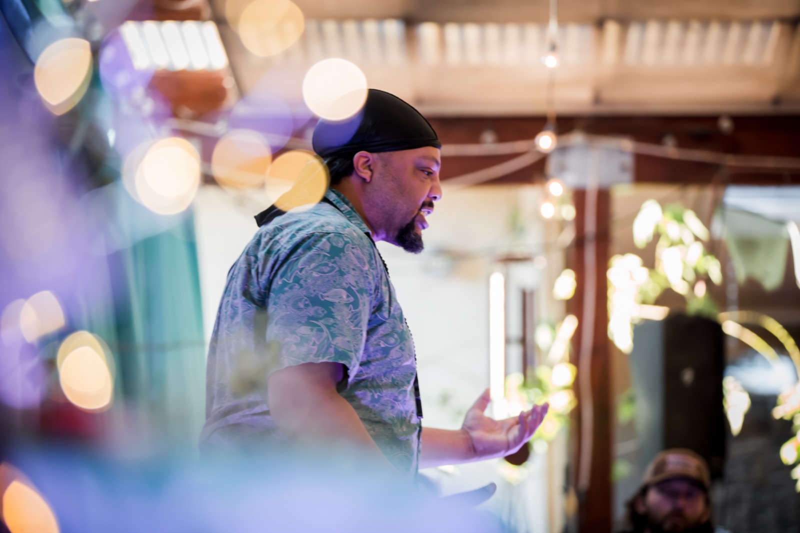A performer surrounded by warm lights at the June showcase